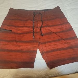 Distortion XL red and black mens board shorts. Zipper pocket on right leg